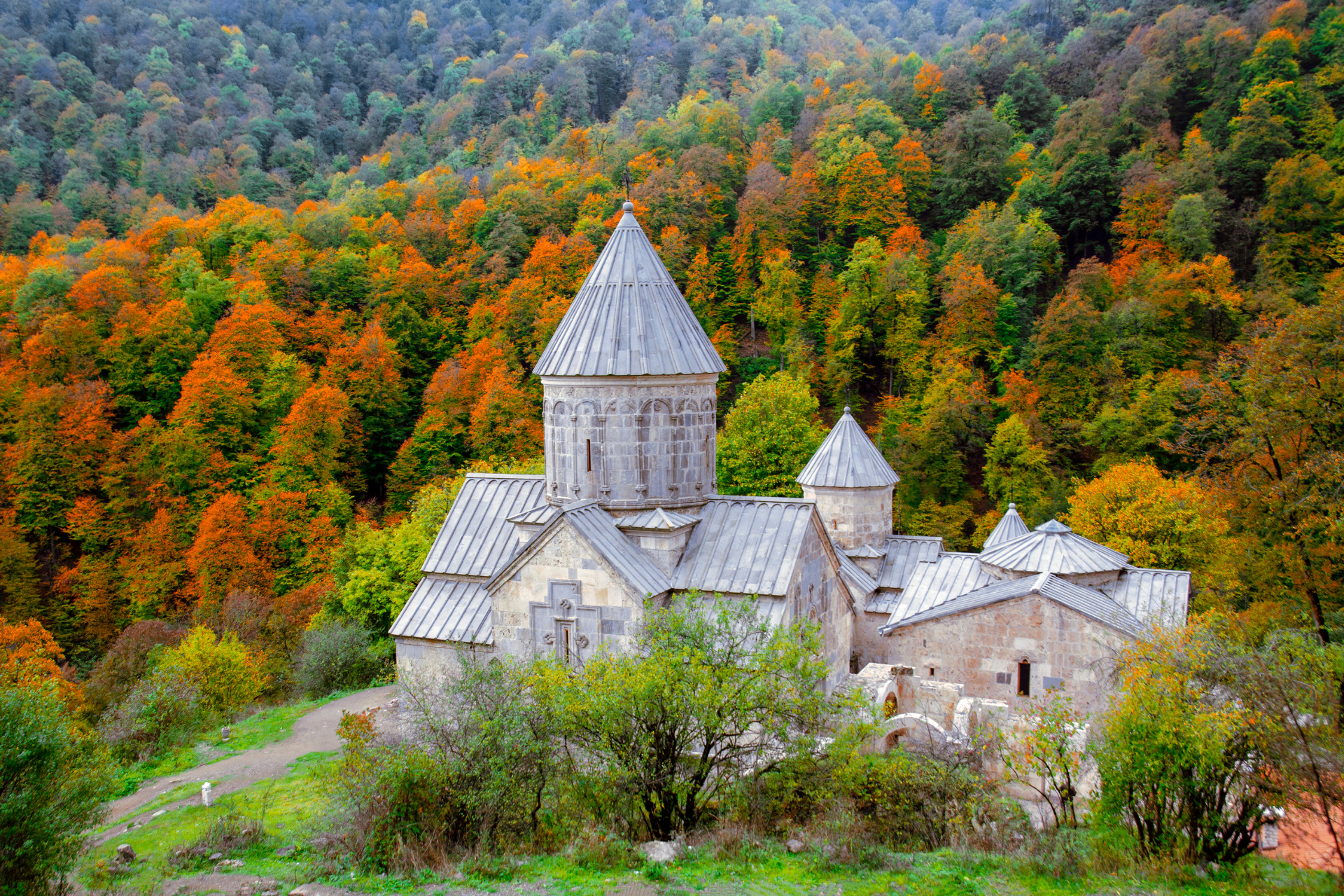 an old church sits in the middle of a forest